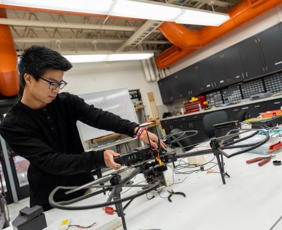 Pacific computer engineering student working on a drone